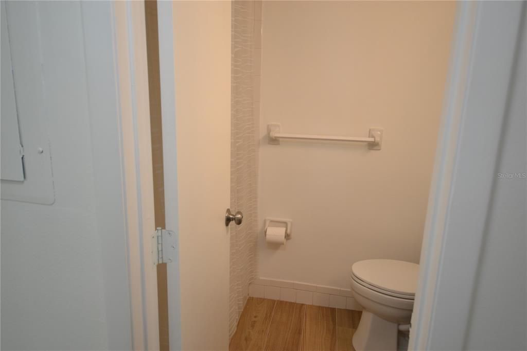 New flooring in guest bathroom with a tub/shower