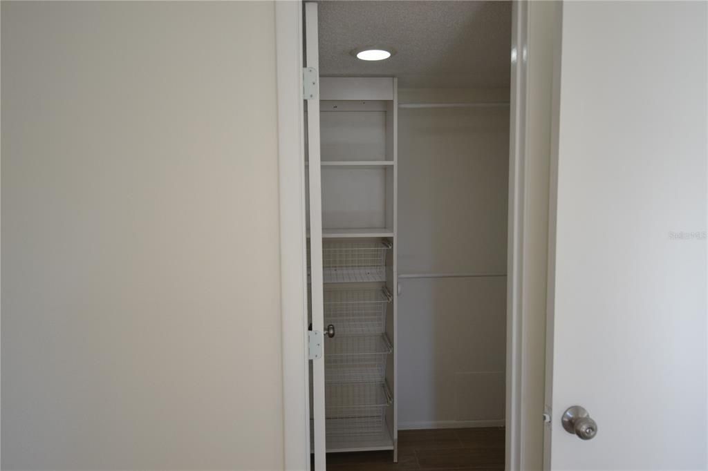 Primary Bedroom largest of 2 closets with shelves