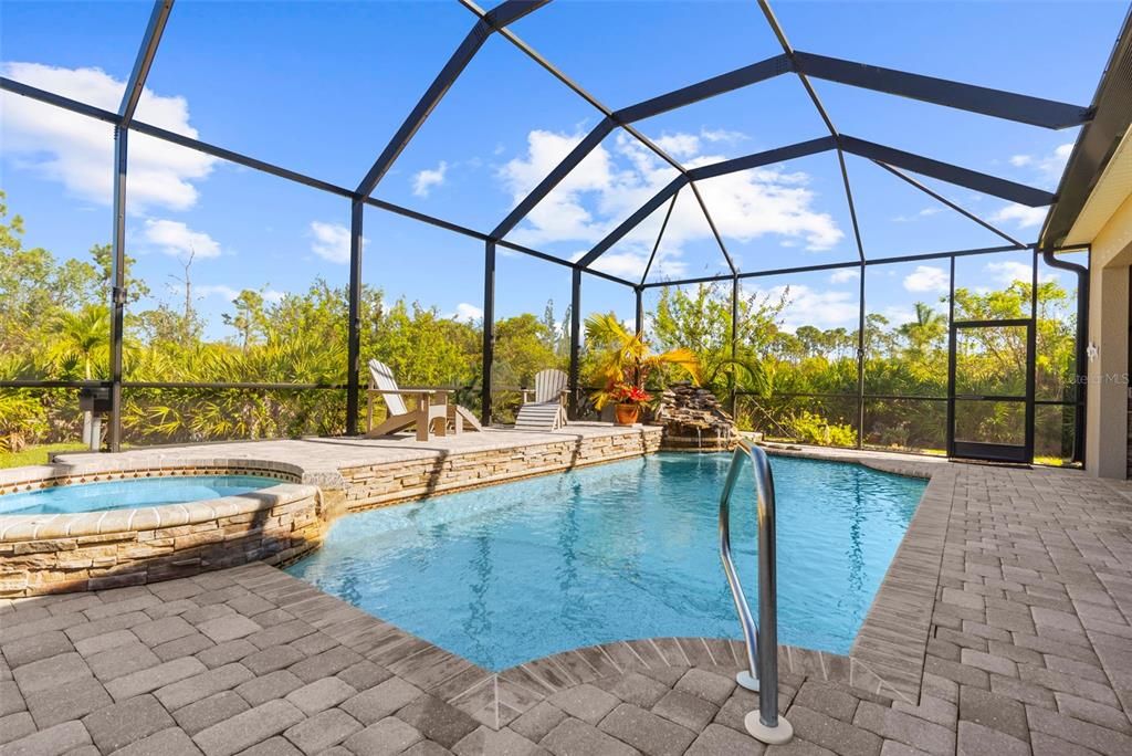 Waterfall and hot tub add to the amazing pool