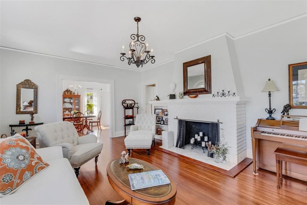 The fireplace serves as the focal point for the living room. It has been capped and is decorative only, but may have the potential to be restored to use