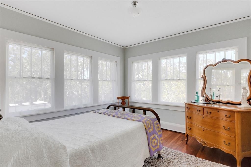 The upstairs rear bedroom is wrapped by windows