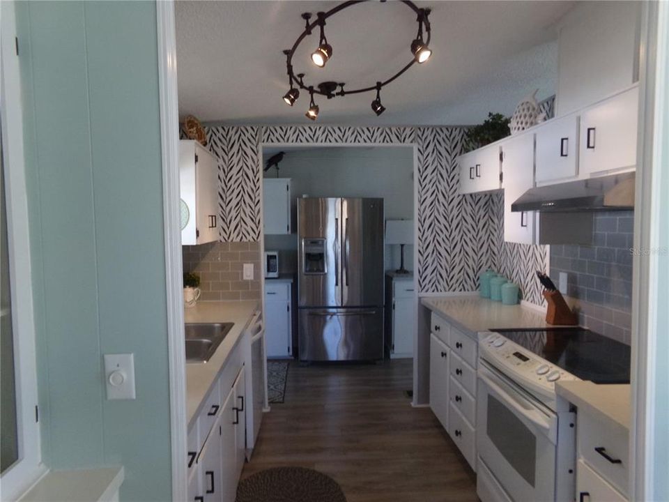 Refrigerator and cabinets were added to hallway for additional storage and counter space