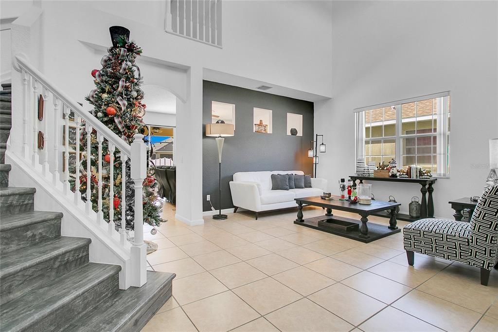 Bright and inviting formal living room designed for relaxation or entertaining, with high ceilings and stylish flooring that complements the home’s modern appeal.