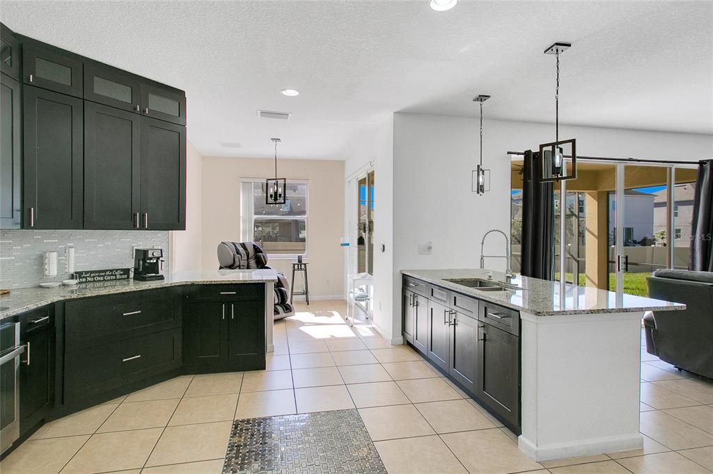 The cozy breakfast nook connected to the kitchen is perfect for everyday meals or informal dinners with guests.