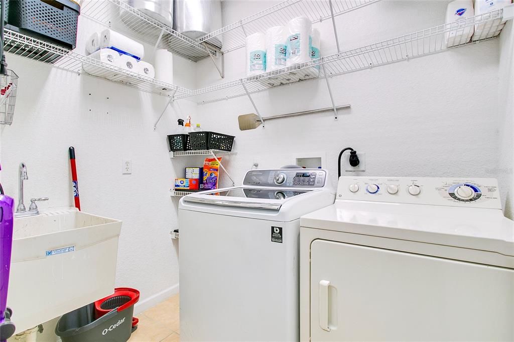 Conveniently located laundry room equipped with washer and dryer hookups, plenty of storage options, and a functional layout for everyday ease.