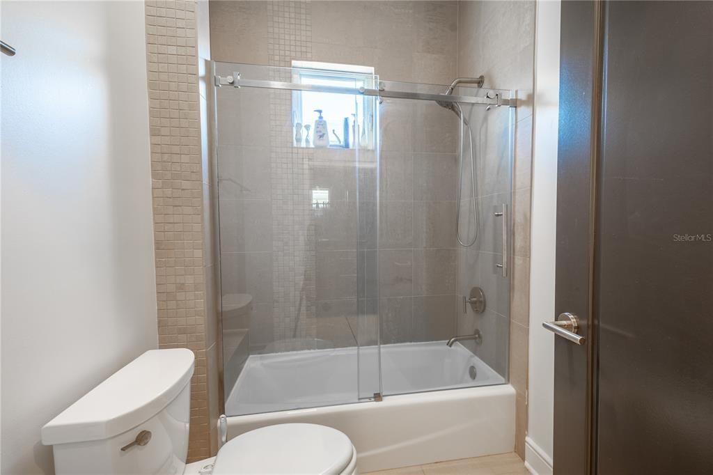 The 2nd bathroom features a tub with shower.