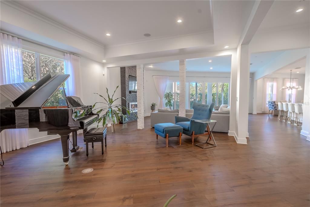 Sophisticated design meets inviting comfort in this spacious living room, complete with a picture window and architectural stone accents.