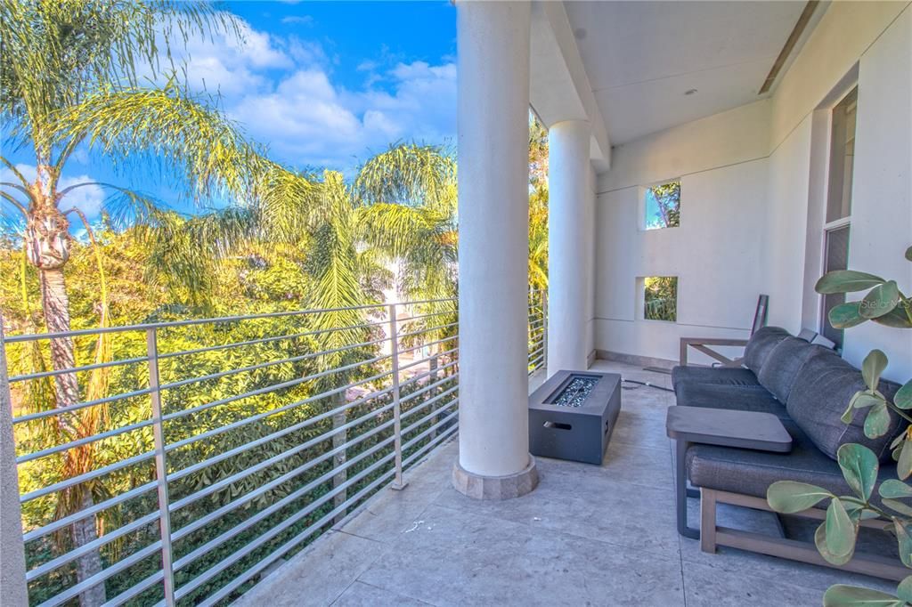 Step out onto the large balcony from the French doors of this serene and airy primary bedroom.