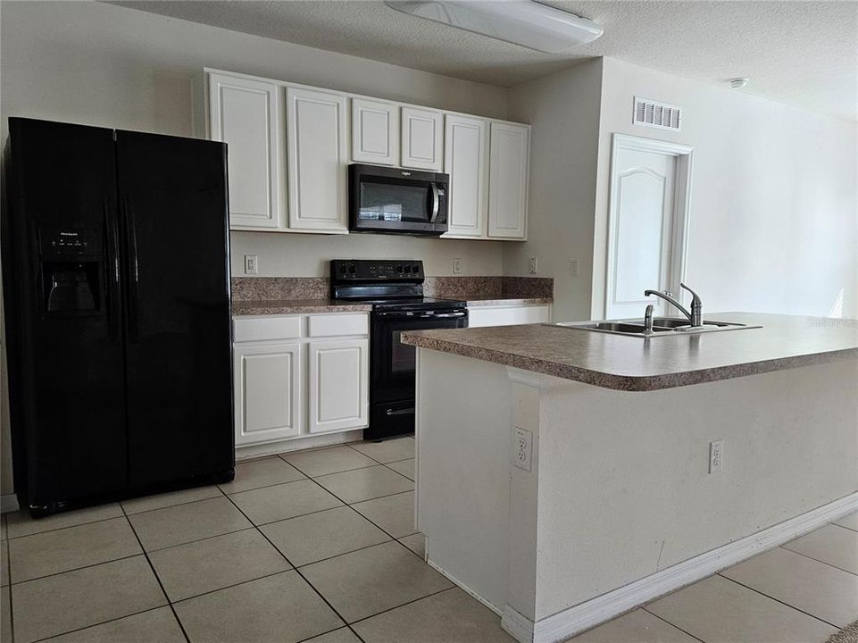 Kitchen with door on right to master bedroom