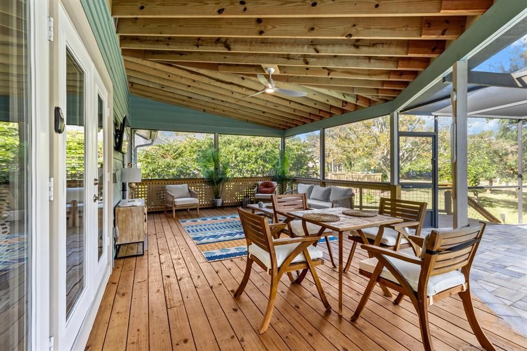 View of covered screened exterior living/dining area