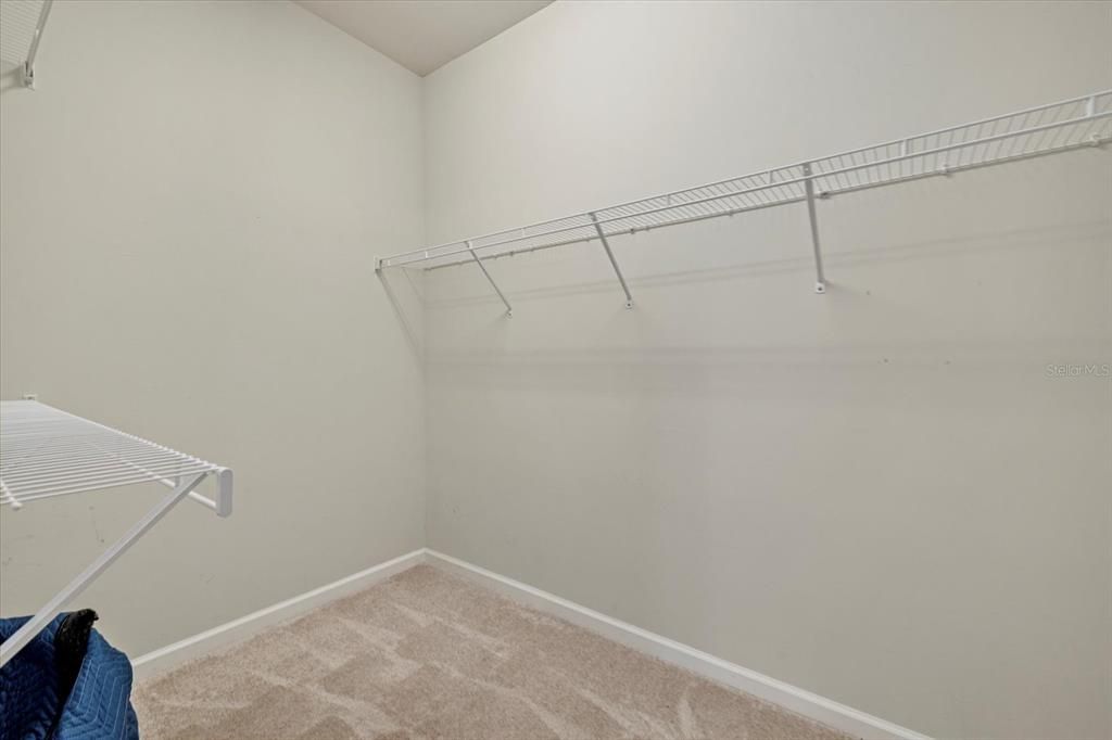 Primary bedroom walk-in closet