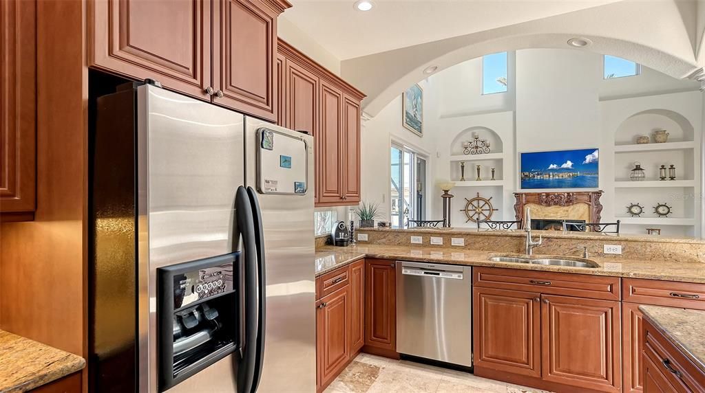 Cherry wood cabinets, stainless steel appliances, granite countertops, travertine flooring.