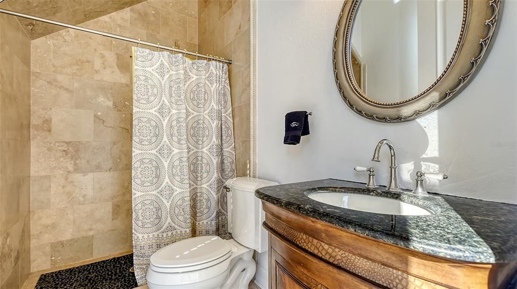 Downstairs bathroom located near guest bedroom