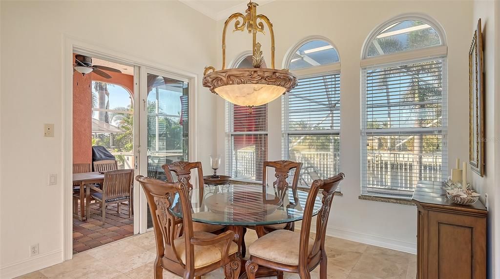 Dining room overlooking pool area & sliding glass doors out to lanai & pool area.