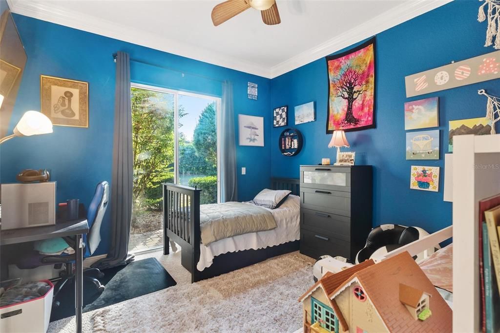 Bedroom Three with Sliding Doors leading to Back Patio