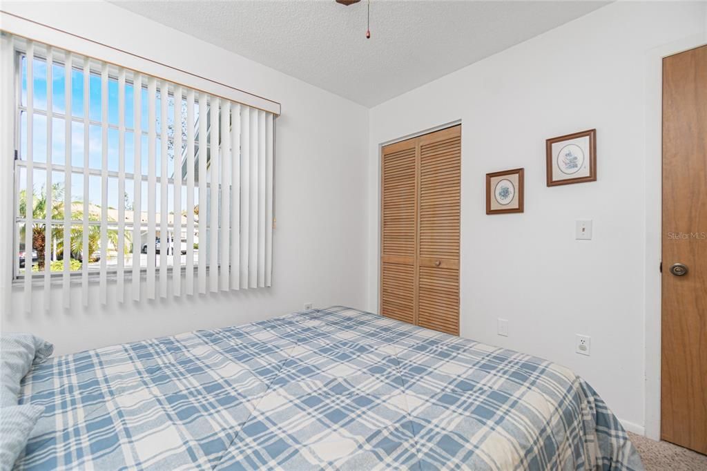 The guest bedroom has a window to let in that natural Florida light and a wall closet.