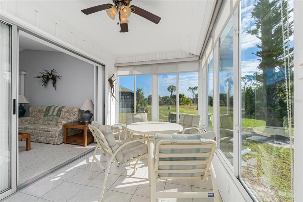 The Florida room has tiled flooring and a ceiling fan.