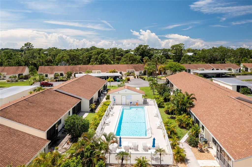 Community pool is surrounded by lush tropical landscaping!