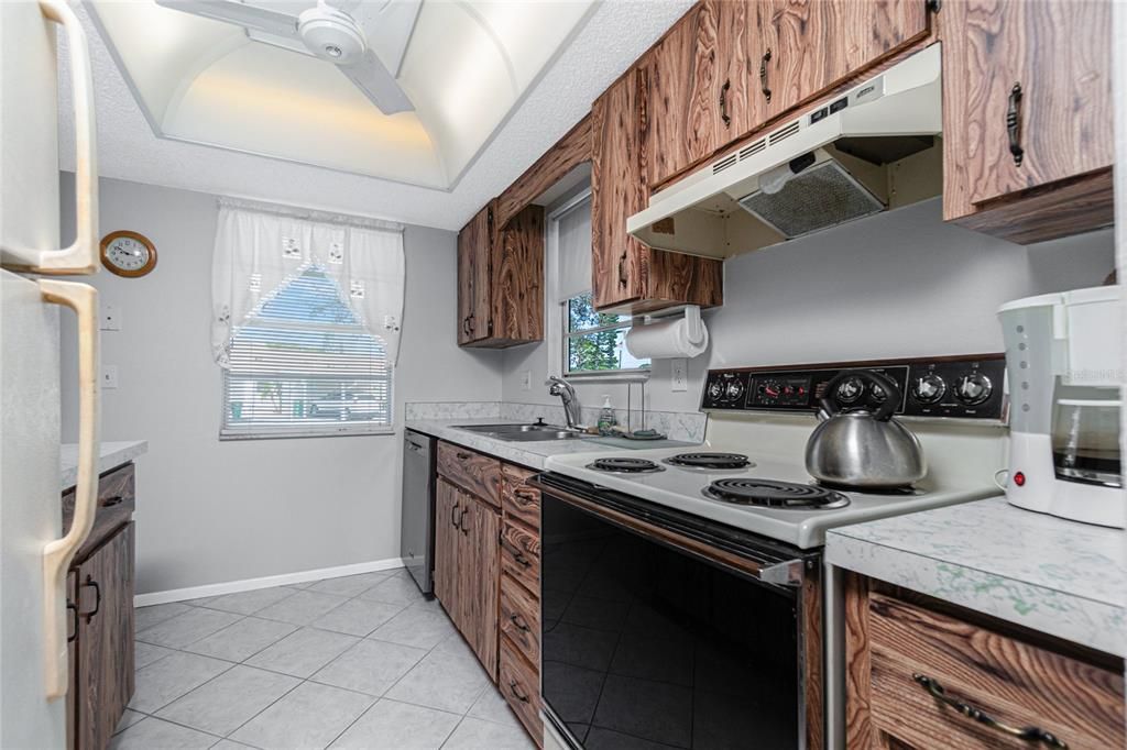 The diagonal tiled flooring is continued into the kitchen.