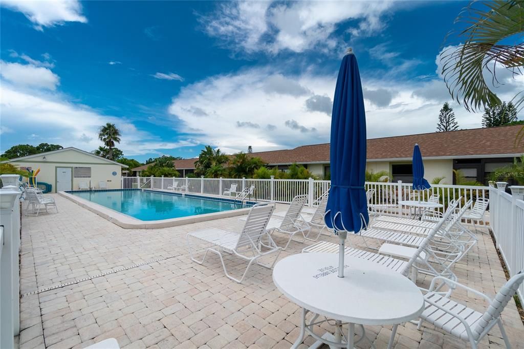 Community heated pool has plenty of sunning space.