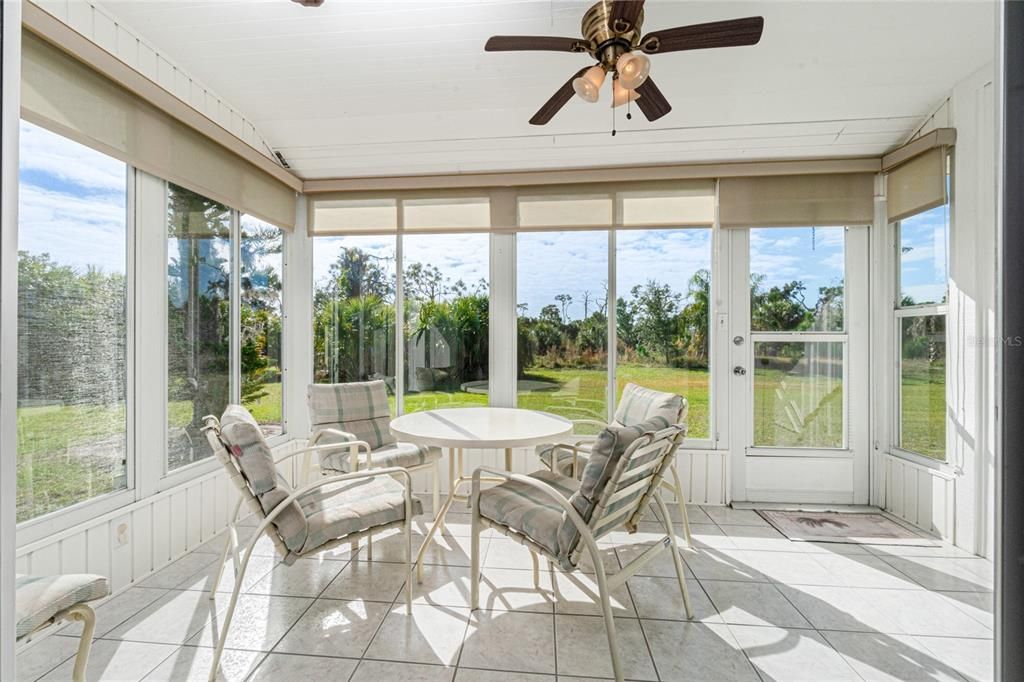 The enclosed Florida room is the perfect space for your morning coffee!