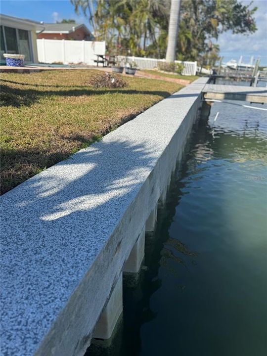 Concrete seawall with epoxied finished cap