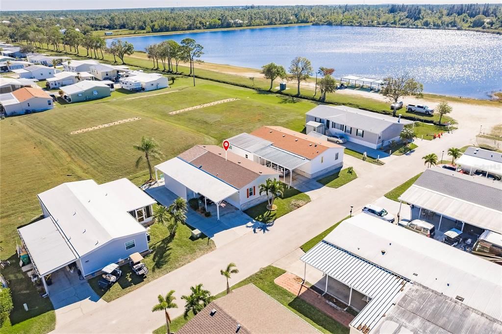 Aerial view of home, lake and green space