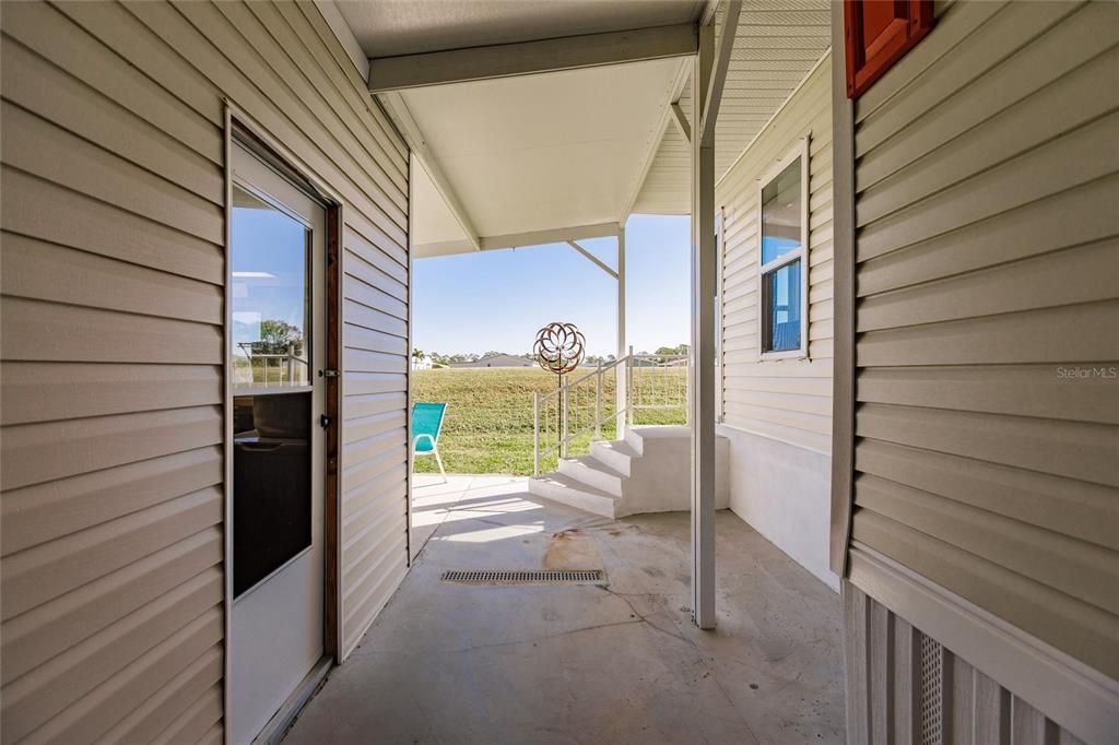 Under carport to rear of home