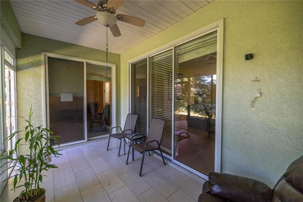 ENCLOSED LANAI WITH 2 SETS OF SLIDING DOORS TO FAMILY ROOM & LIVING ROOM