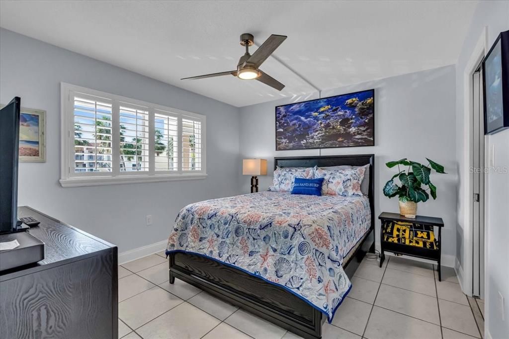 guest bedroom is also ensuite with walk in closet and bath.  Plantation shutters and ceiling fan