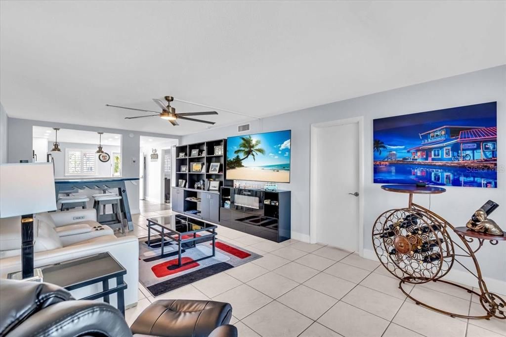 ceiling fan in living room area. 5 in baseboard throughout as well.