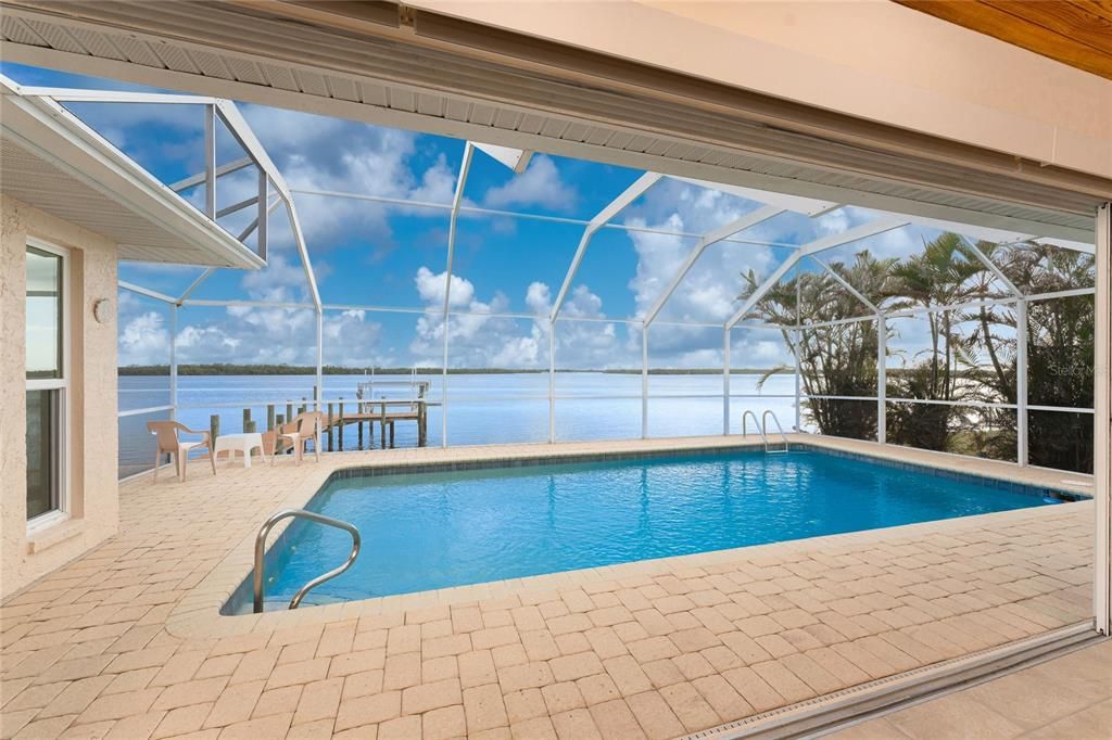 Riverside pool paver deck with corner windows to Living Room