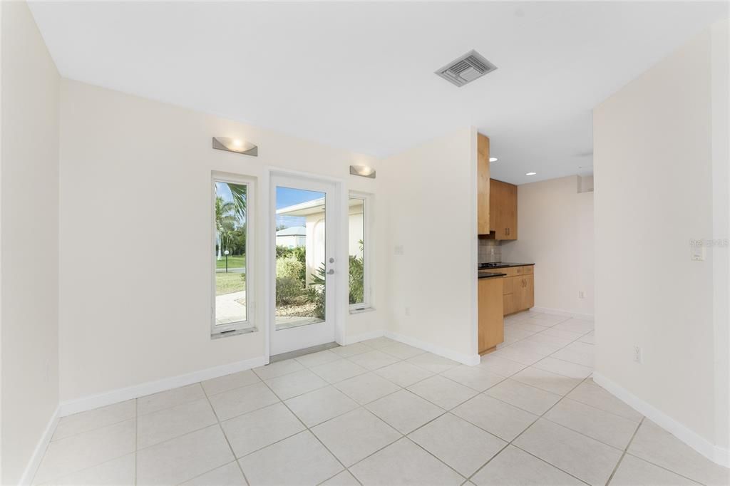 Entry with Kitchen beyond has buffering wall from foyer.