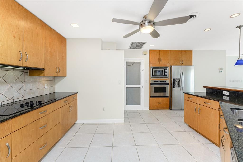 Kitchen features cooktop, & maple cabinetry with dovetail full extension drawers.