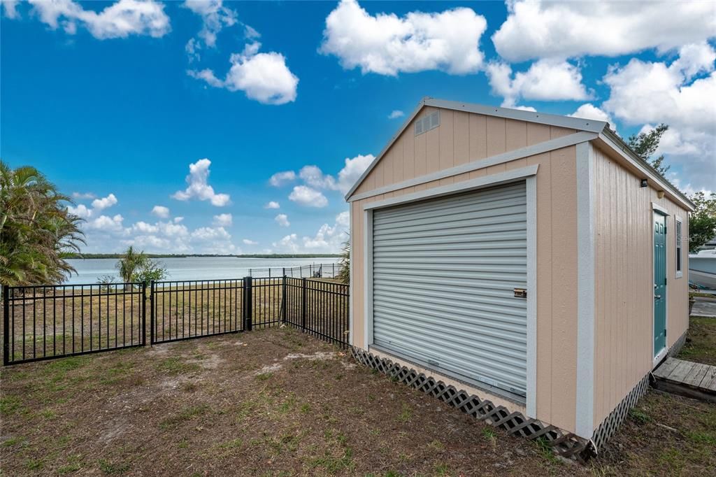 Shed is on extra lot with fenced area & river beyond.