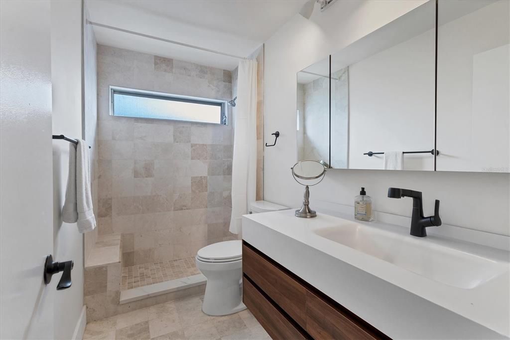 Remodeled Full Second Bathroom and Limestone Faced Walk-In Shower.