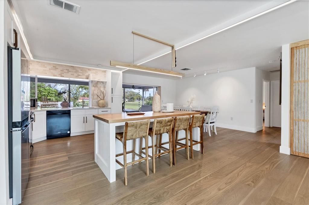 Central Island with Pine Table Surface....Note Pass Through Window over Sink to Lanai.