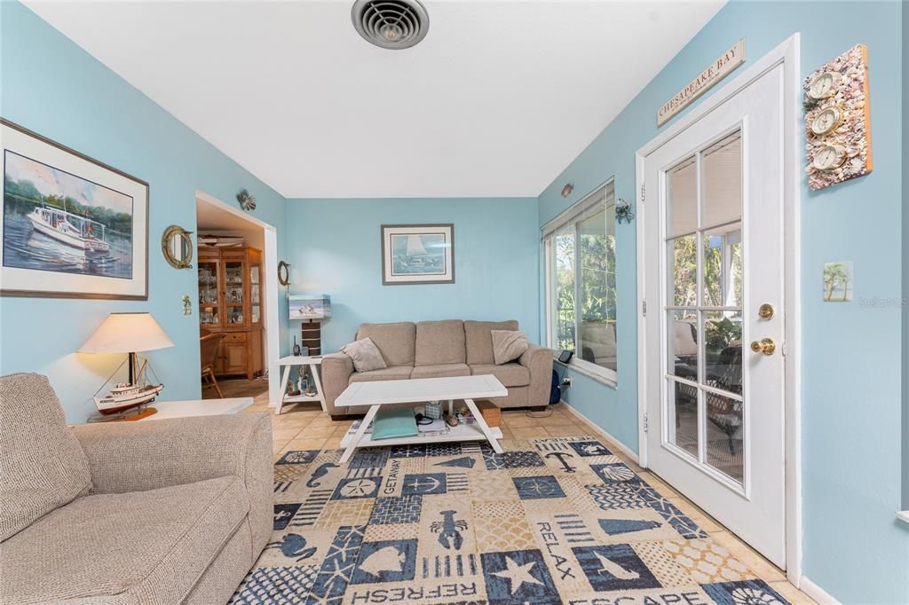 Family room has tiled flooring and opens on to the lanai