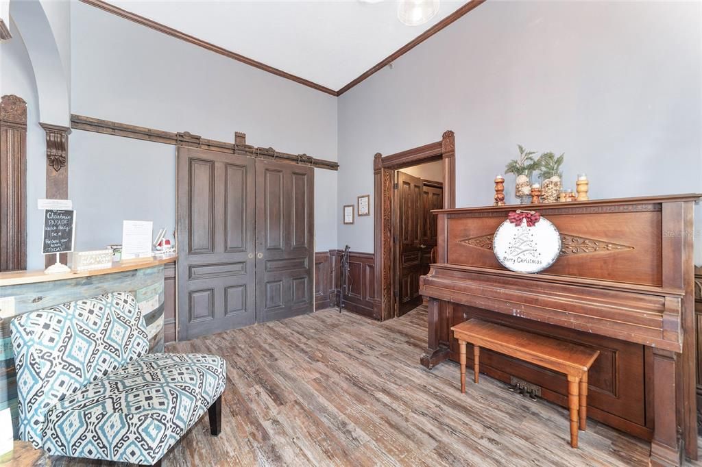 Large wood sliding doors separate the reception area from the waiting and therapy rooms