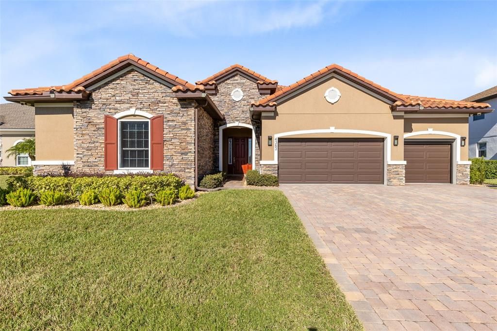 A beautiful front elevation and landscaping greet you upon arrival.