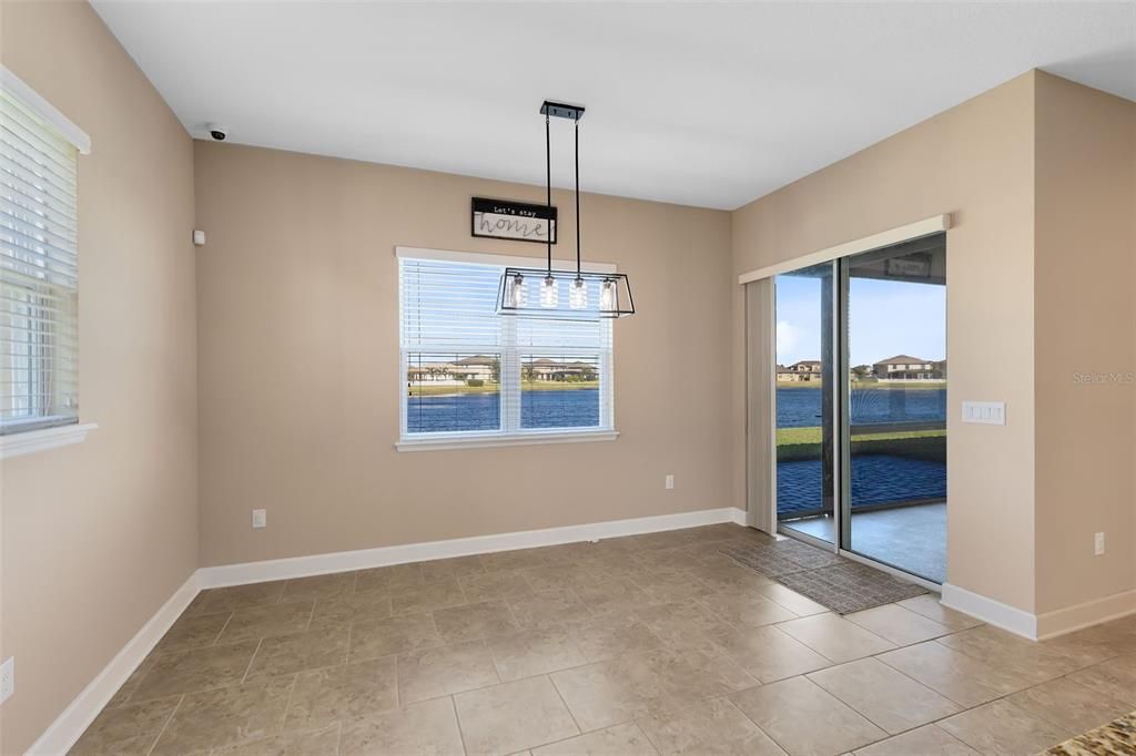 Sliding glass doors from the breakfast nook open to a serene, screened lanai with peaceful pond views – the perfect spot to unwind.