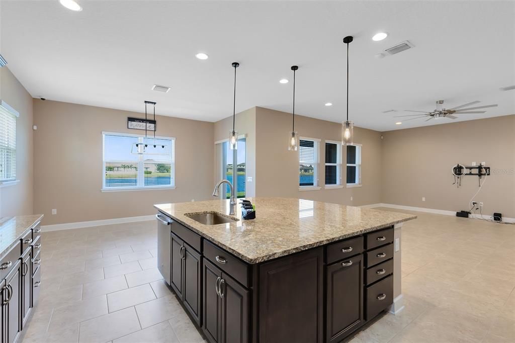 The laundry room includes a sink and ample cabinet storage, keeping things organized and efficient.