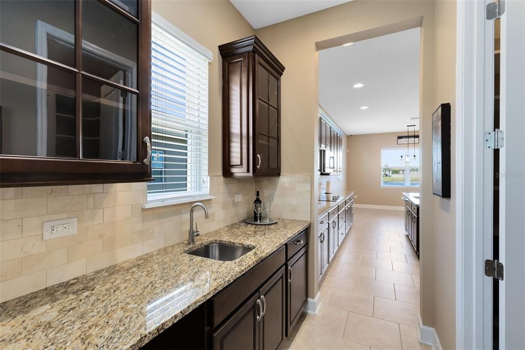 Just off the kitchen, you'll find a Butler’s pantry with a wet bar .