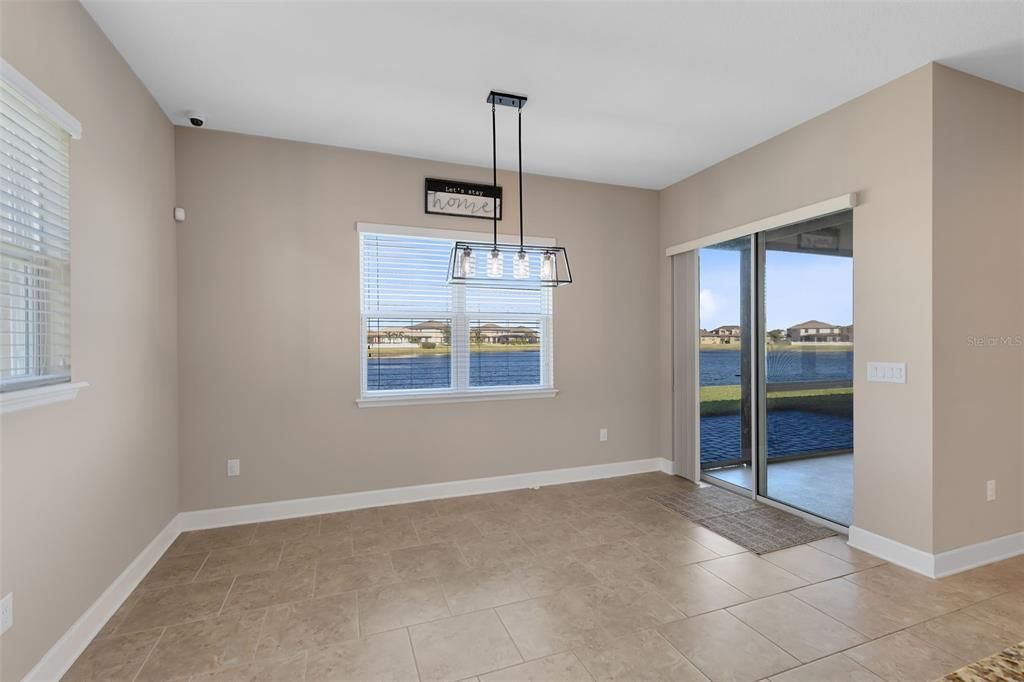 This photo has been virtually staged. A large primary bedroom features a stylish tray ceiling and dual walk-in closets.