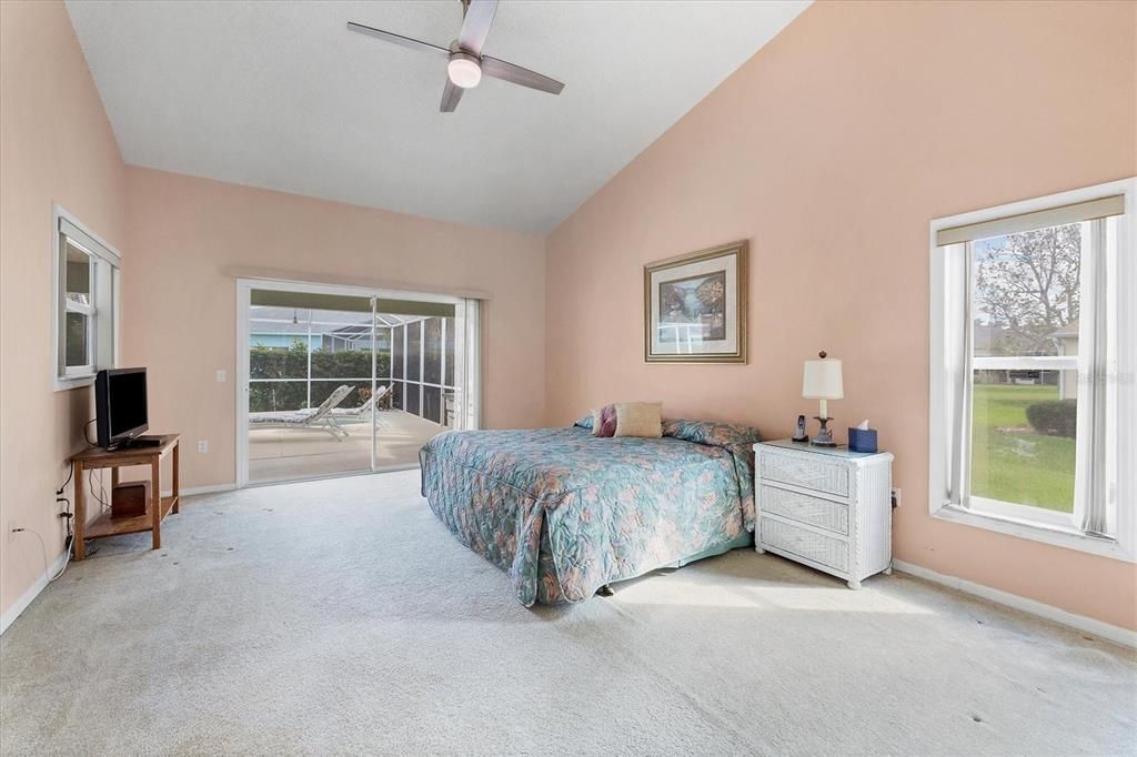 Primary bedroom with slider to pool area