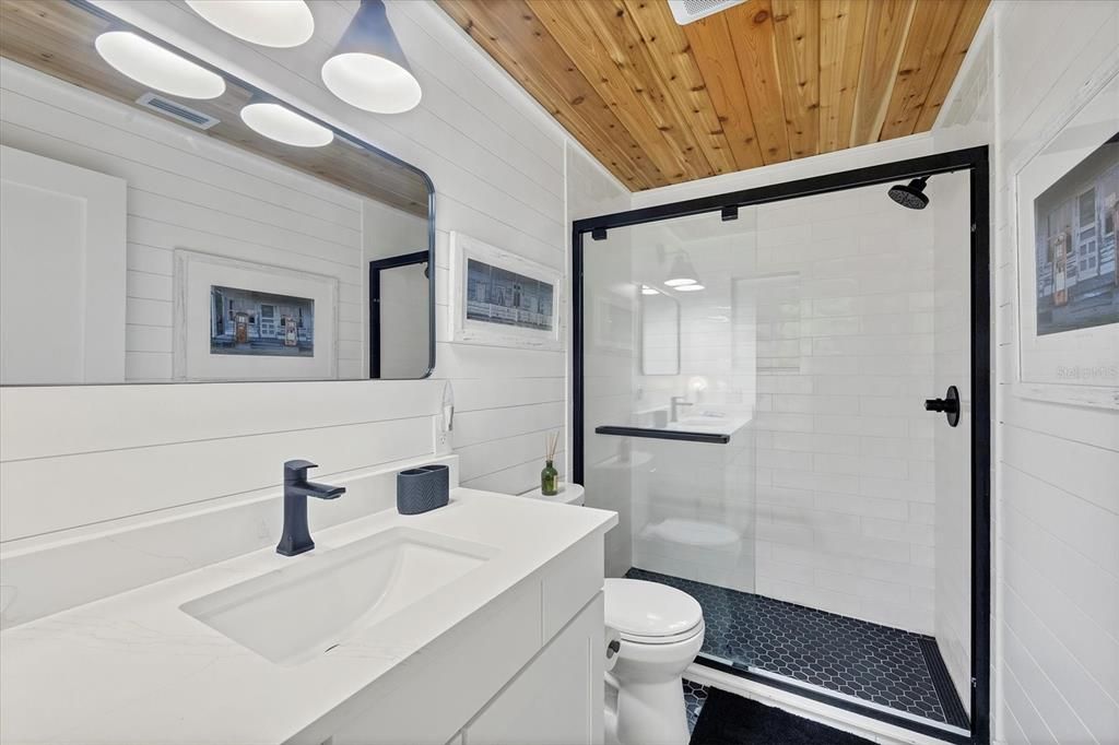 Guest bath with custom cedar tong and groove ceilings.