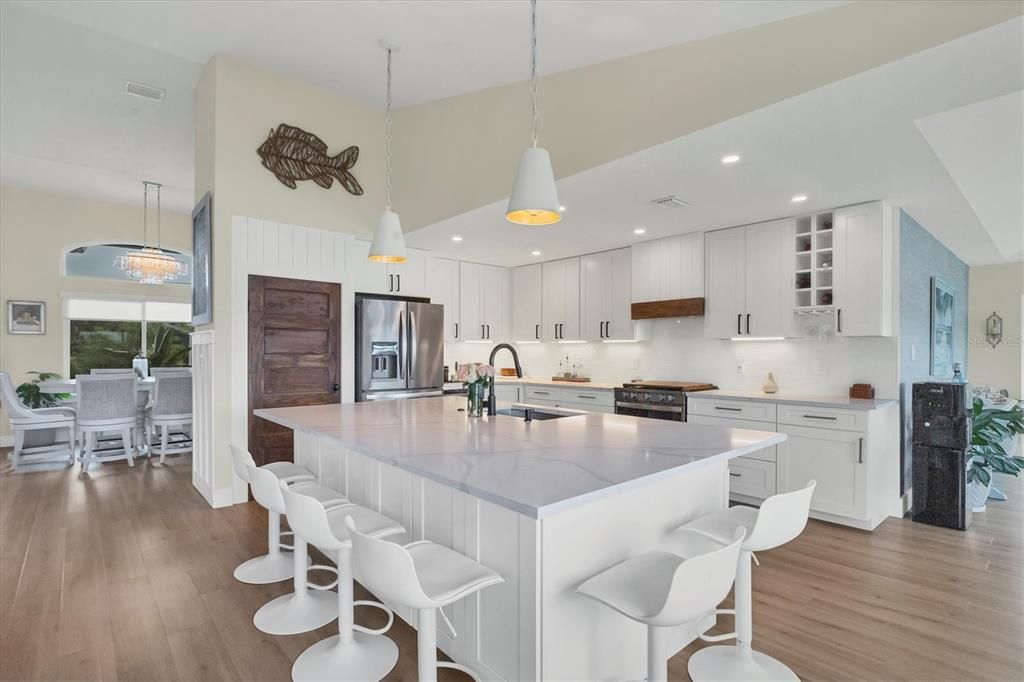 A bright and airy cooks dream kitchen with quartz counter tops.