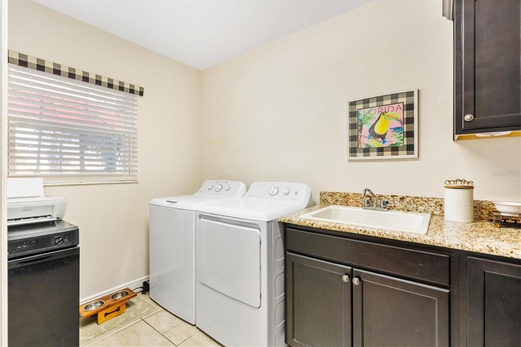 Laundry room with sink and cabinets plus granite