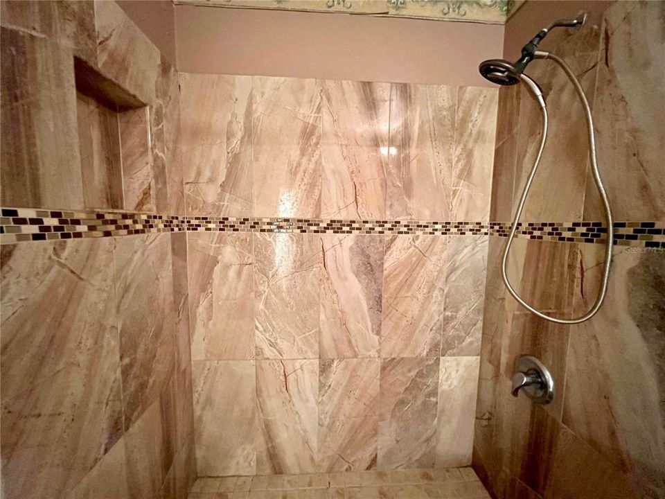 nicely tiled shower in hall bathroom