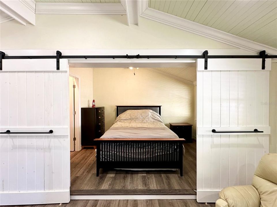 Bedroom with barn doors in Smaller Unit